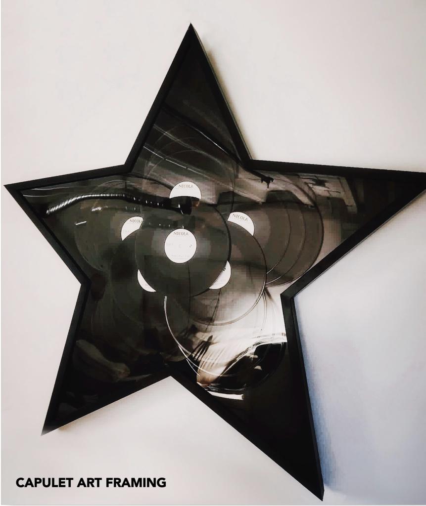 custom picture framing for this star shaped frame encasing 16 vinyl records
